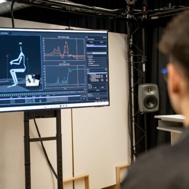 Student Sitting in Momo Lab with Screen and Skeleton