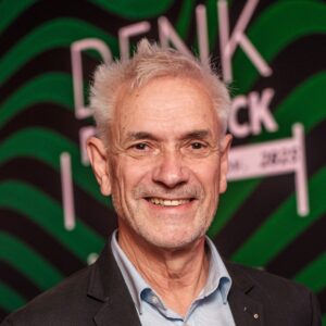 Klaus Lienerbrünn im Portrait vor Denkfrühstück-Aufsteller