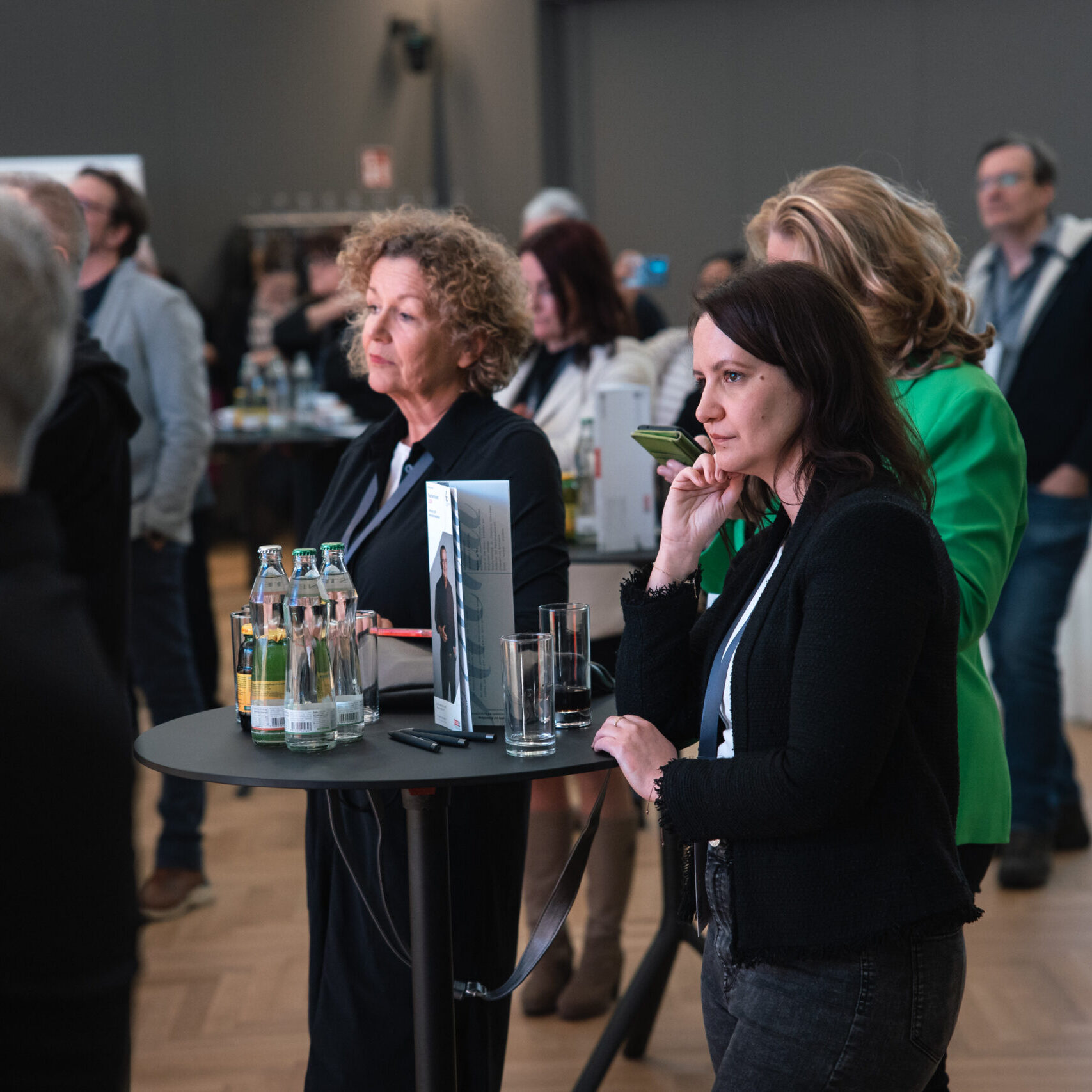 Interessierte Zuhörer bei Stehtischen